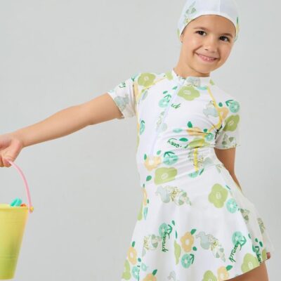 Adorable white floral swim dress with cap, crafted from stretchy polyester knit for comfort and