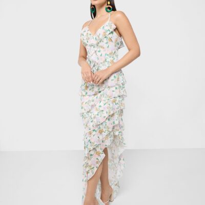 This light, airy dress features a ruffled V-neckline, spaghetti straps, and a high-low hem with