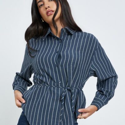 Navy blue striped shirt crafted from a poly blend fabric. Features a collared neckline, long